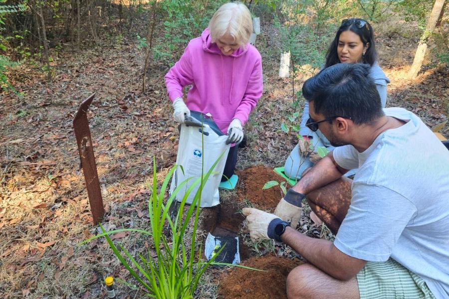 A family planting a memorial tree as an alternative to burial in Perth at Wellington Dam Living Legacy Forest