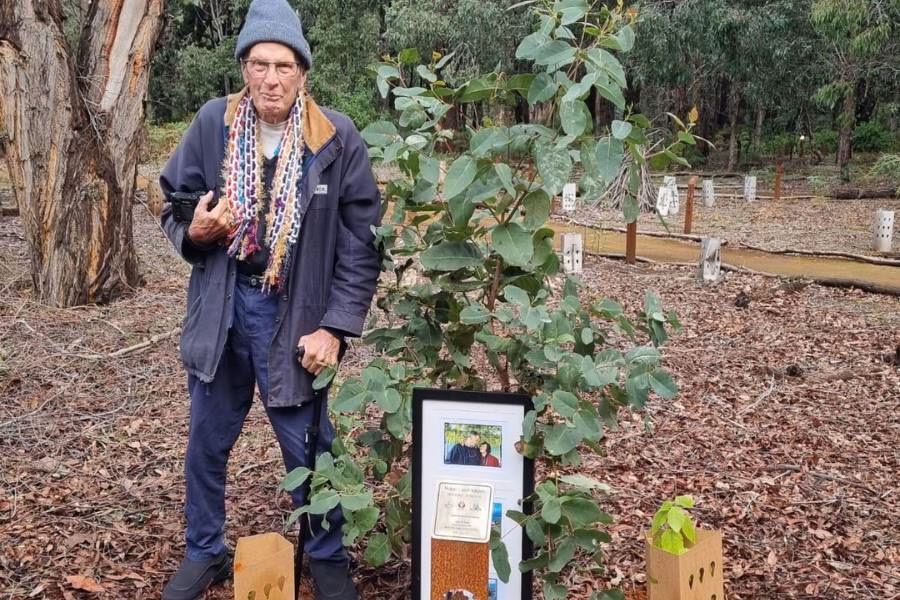 A man planting a memorial tree for their loved ones