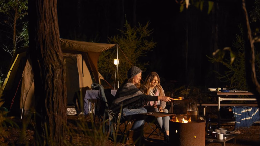 2 womens enjoy bbq time at camping ground